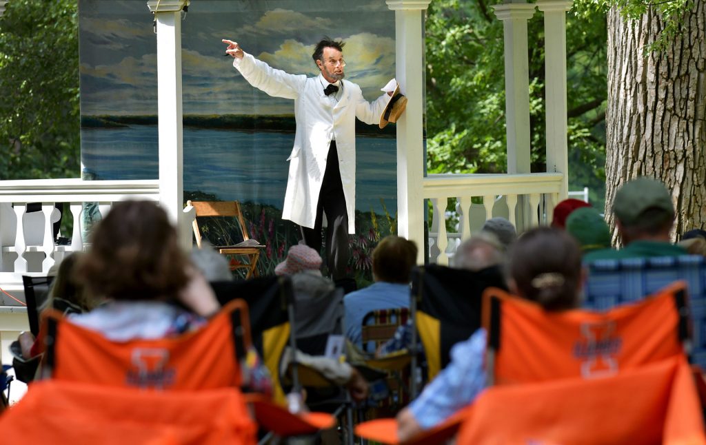 A crowd gathers at the Public Square in Bishop Hill to hear the storytelling of historic re-enactors