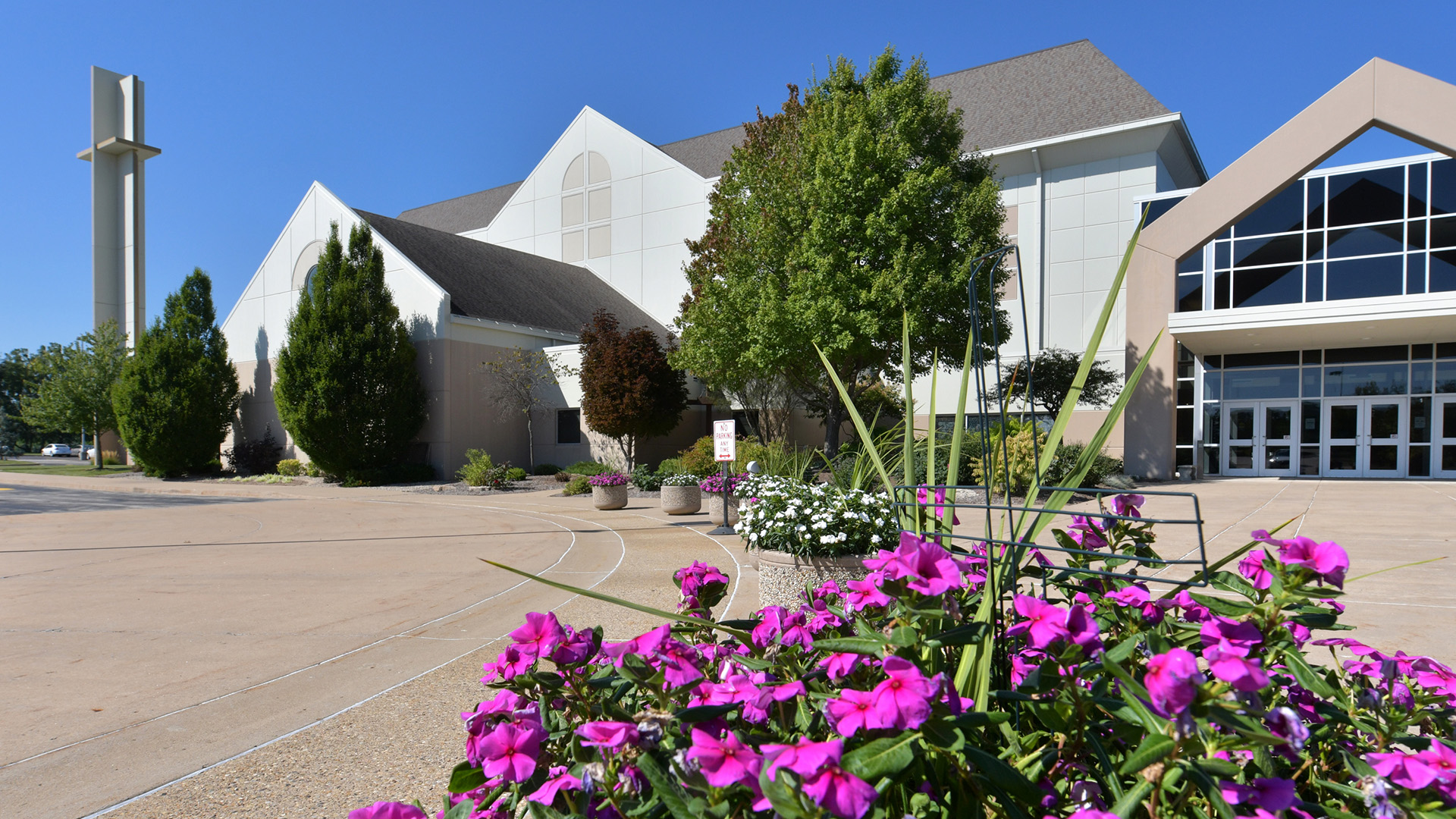 Grace Presbyterian Church in Peoria. Photo to the right, Greg Grindinger, adult ministry pastor at Grace Presbyterian Church, greets parishioners