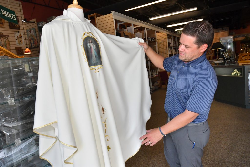 David Gould, owner of Lagron-Miller Company, shows one of the liturgical garments sold at the store