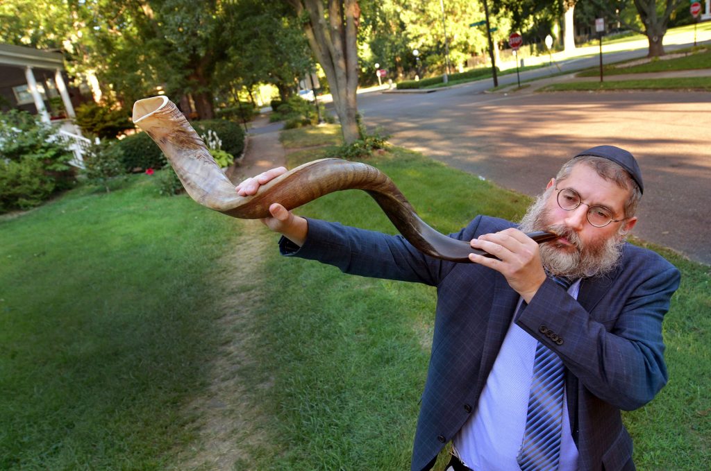 Rabbi Langsam blows the shofar, used for the Jewish observance of Rosh Hashanah