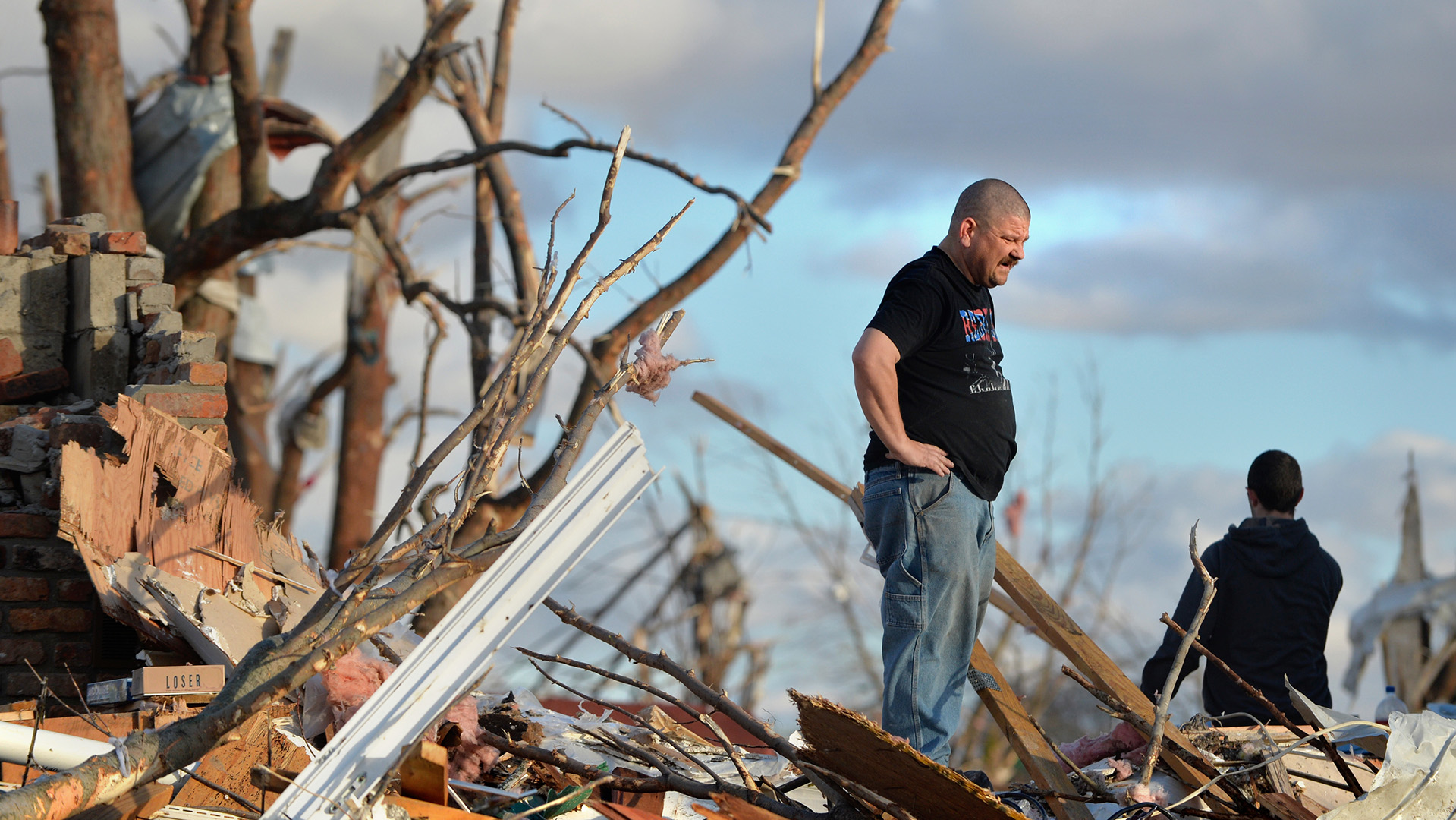 A Washington resident looks over the devastation that destroyed homes on Sunday, Nov.17, 2013
