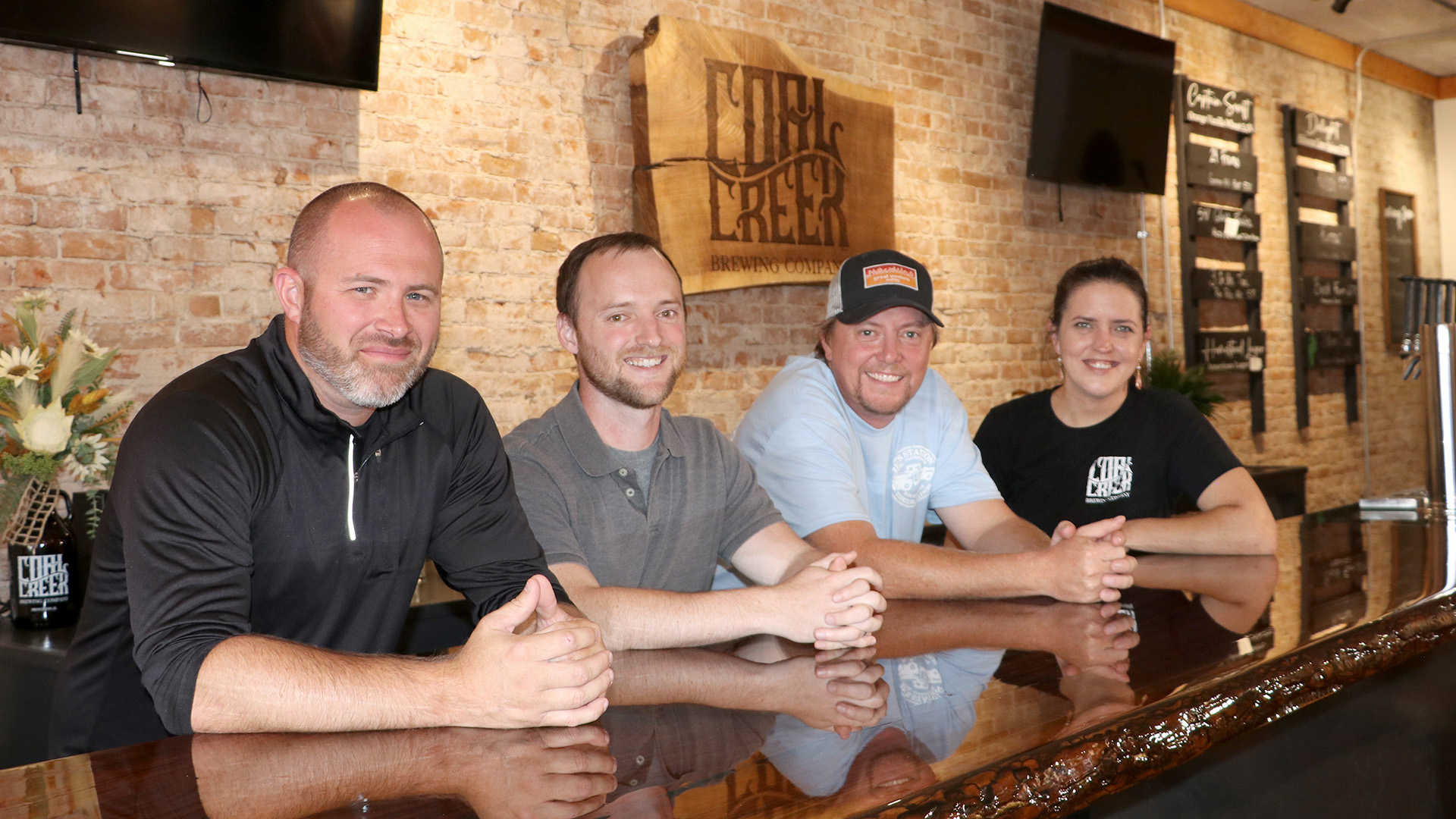 All four owners of the Coal Creek Brewing Company — Mike Grieve, Trevin Kenedy, Justin Stange and Danielle Bender — have ties to farming
